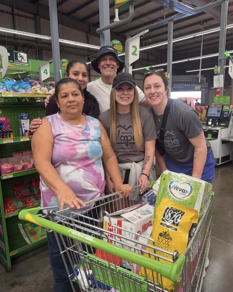 Todd and the team delivering groceries and supplies to a family in need.